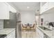 Modern kitchen with granite countertops and stainless steel appliances at 13113 Sanctuary Cove Dr # 104, Temple Terrace, FL 33637