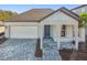 Charming single-story home showcasing a brick driveway, a one car garage and a welcoming covered entry porch at 13728 Sunlight Meadow Dr, Riverview, FL 33578