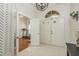 Entryway with geometric wallpaper, view of home office at 5047 Silver Charm Ter, Wesley Chapel, FL 33544