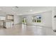 Bright and airy living room with tile floors and sliding glass doors at 4267 Goldfoil Rd, Spring Hill, FL 34609