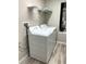 Bright laundry room with washer, dryer, and shelving at 13116 Shumard Way, Riverview, FL 33579
