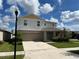 Two story house with light beige siding and teal door at 13116 Shumard Way, Riverview, FL 33579