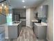 Modern kitchen with gray cabinets, quartz countertops, and stainless steel appliances at 13116 Shumard Way, Riverview, FL 33579