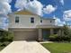 Two story house with light beige siding and teal door at 13116 Shumard Way, Riverview, FL 33579