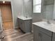 Modern bathroom with dual vanity and grey cabinets at 13116 Shumard Way, Riverview, FL 33579