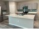 Modern kitchen with gray cabinets, quartz countertops and island at 13116 Shumard Way, Riverview, FL 33579