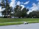 Vacant lot with mature trees and grassy area at 13116 Shumard Way, Riverview, FL 33579