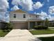 Two story house with light beige siding and teal door at 13116 Shumard Way, Riverview, FL 33579