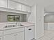 Kitchen with double sink, dishwasher, and pass-through window at 300 S Florida Ave # 500C, Tarpon Springs, FL 34689