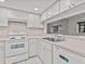 White kitchen with herringbone backsplash and stainless steel appliances at 300 S Florida Ave # 500C, Tarpon Springs, FL 34689