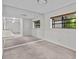 Bright bedroom with mirrored walls and carpeted floor at 300 S Florida Ave # 500C, Tarpon Springs, FL 34689