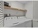 Bright laundry room, features washer, dryer, and shelving at 300 S Florida Ave # 500C, Tarpon Springs, FL 34689