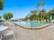 Community pool with lounge chairs and patio tables at 300 S Florida Ave # 500C, Tarpon Springs, FL 34689
