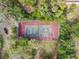 Aerial view of a tennis court nestled in a wooded area at 300 S Florida Ave # 500C, Tarpon Springs, FL 34689