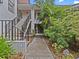 Building exterior with stairs and landscaping, showing units GHI and ABC at 300 S Florida Ave # 500C, Tarpon Springs, FL 34689