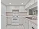 Bright eat-in kitchen, featuring white appliances and a herringbone backsplash at 300 S Florida Ave # 500C, Tarpon Springs, FL 34689