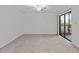 Spacious bedroom with carpet flooring and sliding glass doors at 300 S Florida Ave # 500C, Tarpon Springs, FL 34689