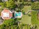 Community pool with surrounding lounge chairs and lush landscaping at 300 S Florida Ave # 500C, Tarpon Springs, FL 34689