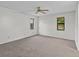 Bright bedroom with ceiling fan and neutral carpeting at 300 S Florida Ave # 500C, Tarpon Springs, FL 34689