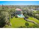 Aerial view of a luxurious home with a pool and expansive lawn at 300 S Florida Ave # 500C, Tarpon Springs, FL 34689