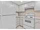 White kitchen with microwave, range, and refrigerator at 300 S Florida Ave # 500C, Tarpon Springs, FL 34689