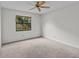 Bedroom with ceiling fan and window overlooking backyard at 300 S Florida Ave # 500C, Tarpon Springs, FL 34689