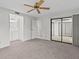 Spacious bedroom with ceiling fan and sliding glass doors at 300 S Florida Ave # 500C, Tarpon Springs, FL 34689