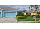 Light blue house with a two car garage and landscaping at 11413 Captiva Kay Dr, Riverview, FL 33569