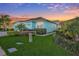 Light blue house with two-car garage and landscaping at 11413 Captiva Kay Dr, Riverview, FL 33569