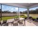 Relaxing screened porch with outdoor dining furniture at 13804 Sunlight Meadow Dr, Riverview, FL 33578