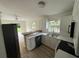 Modern kitchen with white cabinets, wood countertops, and stainless steel appliances at 8518 N Edison Ave, Tampa, FL 33604