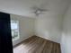Bright bedroom featuring laminate wood floors and a ceiling fan at 8518 N Edison Ave, Tampa, FL 33604