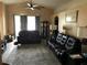 Relaxing living room featuring two reclining sofas and an area rug at 802 Barclay Wood Dr, Ruskin, FL 33570