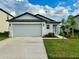 Newly constructed one-story home with a two-car garage and landscaped yard at 31836 Barrel Wave Way, Wesley Chapel, FL 33545