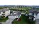 Aerial view of charming house with gray roof and two-car garage at 31836 Barrel Wave Way, Wesley Chapel, FL 33545