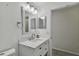 Bright bathroom with white vanity, large mirror, and updated fixtures at 6824 N Sterling Ave, Tampa, FL 33614