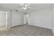 Bedroom with tile floors, ceiling fan, and en-suite bathroom access at 6824 N Sterling Ave, Tampa, FL 33614