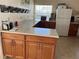 L-shaped kitchen with light countertops and wood cabinets at 7809 39Th N Ave, St Petersburg, FL 33709