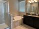 Elegant bathroom with soaking tub, shower, and double vanity at 13240 Satin Lily Dr, Riverview, FL 33579