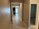 Bright hallway with tile floors, leading to kitchen and bedroom at 13240 Satin Lily Dr, Riverview, FL 33579
