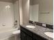 Bathroom with double vanity, granite countertop, and shower/tub combo at 13240 Satin Lily Dr, Riverview, FL 33579