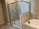Bathroom with shower and soaking tub at 13240 Satin Lily Dr, Riverview, FL 33579