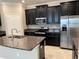 Modern kitchen with stainless steel appliances and granite countertops at 13240 Satin Lily Dr, Riverview, FL 33579