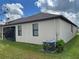 House exterior showcasing AC unit and screened patio at 13240 Satin Lily Dr, Riverview, FL 33579