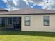 Rear view of house with screened patio, and lawn at 13240 Satin Lily Dr, Riverview, FL 33579
