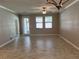 Open living room with tile floors and access to patio at 13240 Satin Lily Dr, Riverview, FL 33579