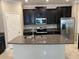 Modern kitchen with stainless steel appliances and granite countertops at 13240 Satin Lily Dr, Riverview, FL 33579