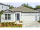 Charming single-story home boasts a well-manicured front yard and a convenient two-car garage at 13806 Sunlight Meadow Dr, Riverview, FL 33578