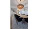 This dining room features a wooden table, soft black chairs, and an interesting chandelier at 559 W Davis Blvd, Tampa, FL 33606