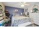 Charming bedroom with a floral bedspread and ceiling fan at 12133 Spartan Way # 204, Hudson, FL 34667